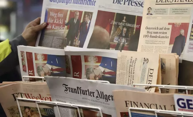 Newspapers are seen on a sales stand in Vienna, Austria, Tuesday, Jan 7, 2025. (AP Photo/Heinz-Peter Bader)