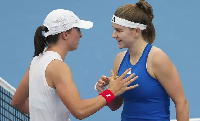 Poland's Iga Swiatek, left, is congratulated by Czech Republic's Karolina Muchova following their match at the United Cup tennis tournament in Sydney, Australia, Wednesday, Jan. 1, 2025. (AP Photo/Mark Baker)