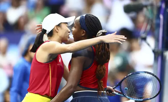 Coco Gauff of the United States, right, after defeating Shuai Zhang of China in their United Cup tennis match in Perth, Australia, Wednesday, Jan. 1, 2025. (AP Photo/Trevor Collens)