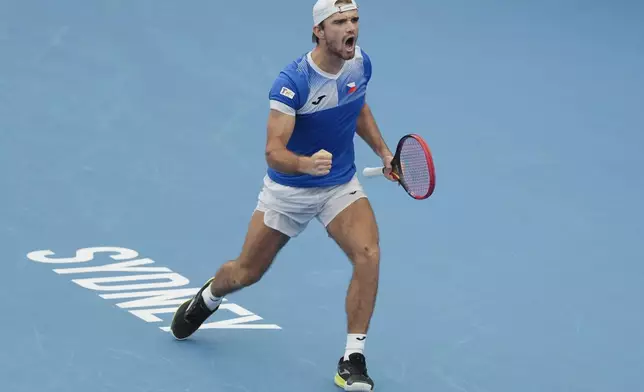 Czech Republic's Tomas Machac celebrates after defeating Poland's Hubert Hurkaz during their match at the United Cup tennis tournament in Sydney, Australia, Wednesday, Jan. 1, 2025. (AP Photo/Mark Baker)