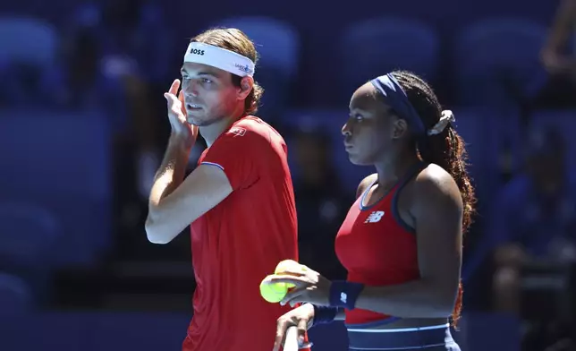 Taylor Fritz and Coco Gauff of the United States talk between point against Petra Marcinko and Ivan Dodig of Croatia during their United Cup mixed doubles tennis match in Perth, Australia, Tuesday, Dec. 31, 2024. (AP Photo/Trevor Collens)