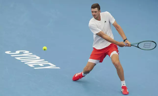 Poland's Hubert Hurkaz plays a backhand return to Czech Republic's Tomas Machac during their match at the United Cup tennis tournament in Sydney, Australia, Wednesday, Jan. 1, 2025. (AP Photo/Mark Baker)