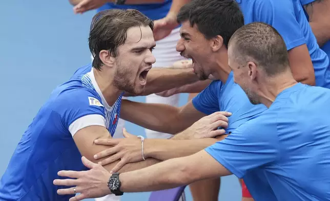 Czech Republic's Tomas Machac celebrates teammates after defeating Poland's Hubert Hurkaz during their match at the United Cup tennis tournament in Sydney, Australia, Wednesday, Jan. 1, 2025. (AP Photo/Mark Baker)