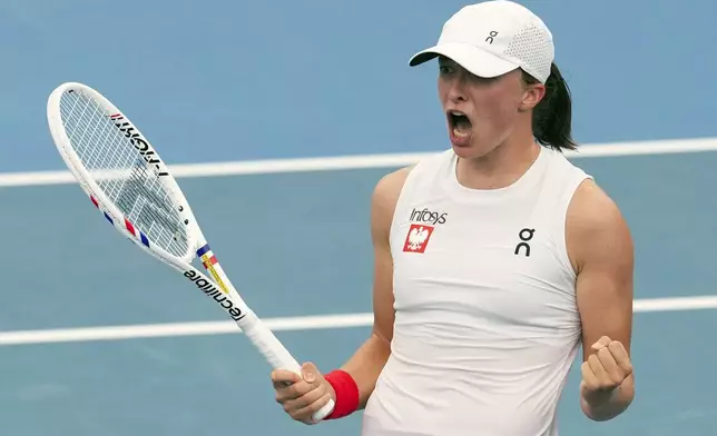 Poland's Iga Swiatek celebrates after defeating Czech Republic's Karolina Muchova during their match at the United Cup tennis tournament in Sydney, Australia, Wednesday, Jan. 1, 2025. (AP Photo/Mark Baker)