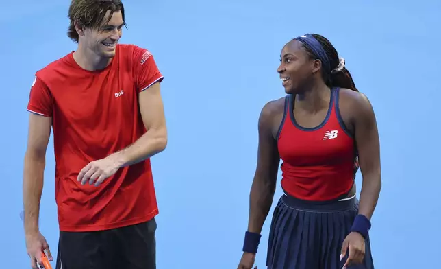 Taylor Fritz and Coco Gauff of the United States laugh as they celebrate defeating Petra Marcinko and Ivan Dodig of Croatia in their United Cup mixed doubles tennis match in Perth, Australia, Tuesday, Dec. 31, 2024. (AP Photo/Trevor Collens)