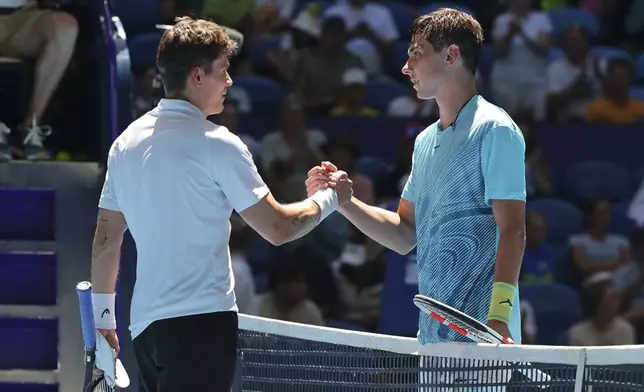 Alexander Shevchenko of Kazakhstan, right, shakes hands with Daniel Masur of Germany after winning their United Cup tennis match in Perth, Australia, Wednesday, Jan. 1, 2025. (AP Photo/Trevor Collens)