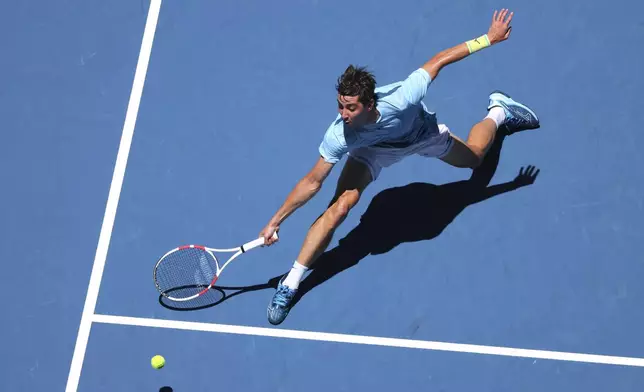 Alexander Shevchenko of Kazakhstan stretches to reach the ball from to Daniel Masur of Germany during their United Cup tennis match in Perth, Australia, Wednesday, Jan. 1, 2025. (AP Photo/Trevor Collens)