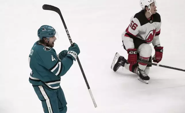 San Jose Sharks defenseman Cody Ceci, left, reacts after scoring a goal next to New Jersey Devils left wing Erik Haula (56) during the third period of an NHL hockey game in San Jose, Calif., Saturday, Jan. 4, 2025. (AP Photo/Jeff Chiu)