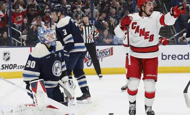 Carolina Hurricanes' Seth Jarvis, right, celebrates after a goal against the Columbus Blue Jackets during the first period of an NHL hockey game Tuesday, Dec. 31, 2024, in Columbus, Ohio. (AP Photo/Jay LaPrete)