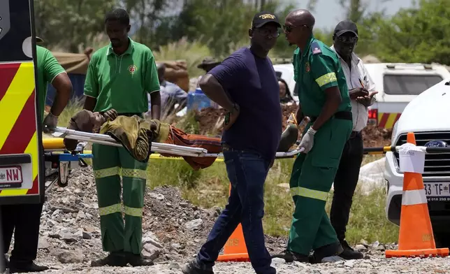 A miner is transported on a stretcher by rescue workers after he was rescued from below ground in an abandoned gold mine in Stilfontein, South Africa, Tuesday, Jan. 14, 2025. (AP Photo/Themba Hadebe)