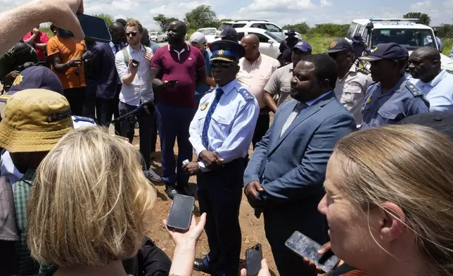 The Acting Provincial Commissioner of North West, Major General Patrick Asaneng, centre, speaks to journalists outside an abandoned gold mine, where miners were rescued from below ground, in Stilfontein, South Africa, Thursday, Jan. 16, 2025. (AP Photo/Themba Hadebe)