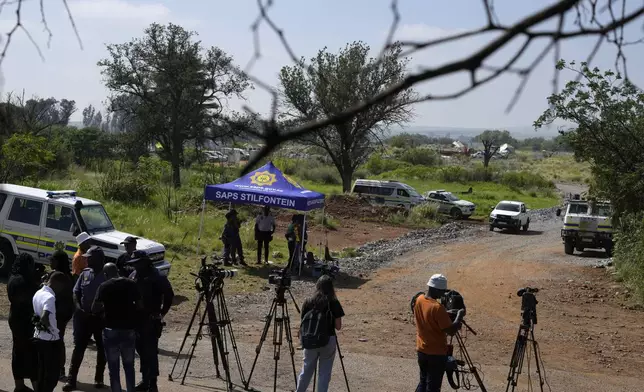 Journalists are seen during a stake-out at an abandoned gold mine, where miners were rescued from below ground, in Stilfontein, South Africa, Thursday, Jan. 16, 2025. (AP Photo/Themba Hadebe)