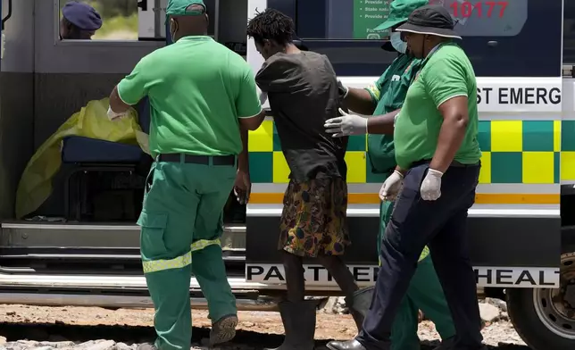 Rescuer workers assist an illegal miner who has been trapped deep in an abandoned gold mine for months, in Stilfontein, South Africa, Tuesday, Jan. 14, 2025. (AP Photo/Themba Hadebe)