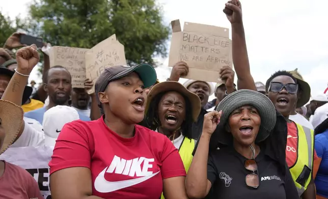 Families of miners and activist protest as South Africa's Police minister Senzo Mchunu visit an abandoned gold mine, where miners are rescued from below ground in an abandoned gold mine in Stilfontein, South Africa, Tuesday, Jan. 14, 2025. (AP Photo/Themba Hadebe)