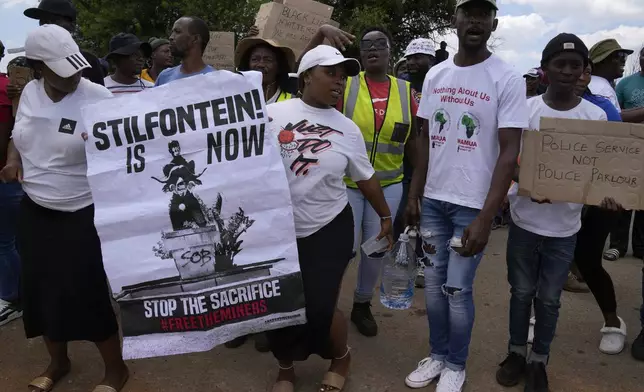 Families of miners and activist protest as South Africa's Police minister Senzo Mchunu visit an abandoned gold mine, where miners are rescued from below ground in an abandoned gold mine in Stilfontein, South Africa, Tuesday, Jan. 14, 2025. (AP Photo/Themba Hadebe)