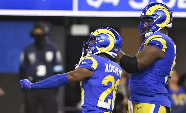 Los Angeles Rams safety Kamren Kinchens, left, celebrates after intercepting a pass during the second half of an NFL football game against the Arizona Cardinals, Saturday, Dec. 28, 2024, in Inglewood, Calif. (AP Photo/Alex Gallardo)