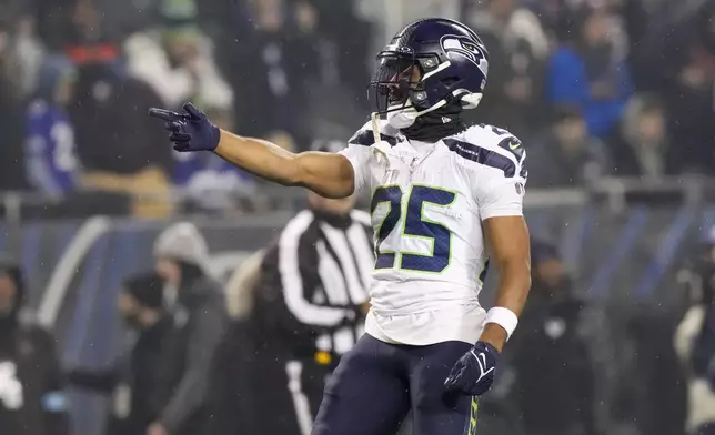 Seattle Seahawks running back Kenny McIntosh gestures after a play against the Chicago Bears during the first half of an NFL football game, Thursday, Dec. 26, 2024, in Chicago. (AP Photo/Nam Y. Huh)