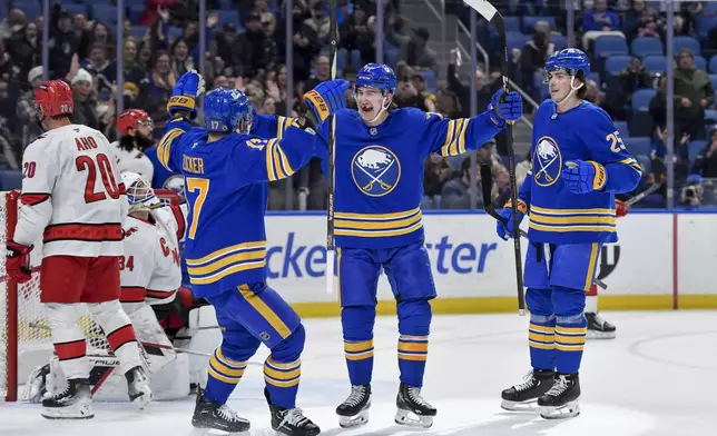 Buffalo Sabres center Ryan McLeod, center, celebrates with left wing Jason Zucker, left, and defenseman Owen Power (25) after scoring during the second period of an NHL hockey game against the Carolina Hurricanes in Buffalo, N.Y., Wednesday, Jan. 15, 2025. (AP Photo/Adrian Kraus)