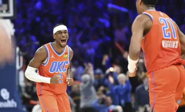 Oklahoma City Thunder guard Shai Gilgeous-Alexander, left, celebrates after guard Aaron Wiggins, right, made a basket during the second half of an NBA basketball game against the New York Knicks, Friday, Jan 3, 2025, in Oklahoma City. (AP Photo/Kyle Phillips)