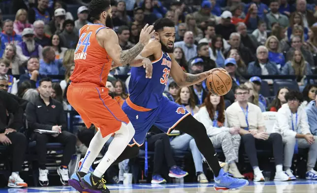 New York Kincks center Karl-Anthony Towns, right, pushes past Oklahoma City Thunder forward Kenrich Williams, left, during the first half of an NBA basketball game, Friday, Jan. 3, 2025, in Oklahoma City. (AP Photo/Kyle Phillips)