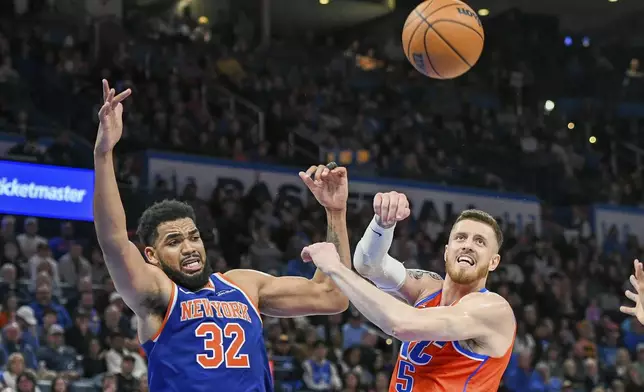 Oklahoma City Thunder center Isaiah Hartenstein, right, tries to get to a rebound before New York Knicks center Karl-Anthony Towns, left, during the second half of an NBA basketball game, Friday, Jan 3, 2025, in Oklahoma City. (AP Photo/Kyle Phillips)