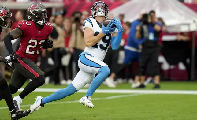 Carolina Panthers wide receiver Adam Thielen catches a touchdown pass against the Tampa Bay Buccaneers during the first half of an NFL football game Sunday, Dec. 29, 2024, in Tampa, Fla. (AP Photo/Chris O'Meara)