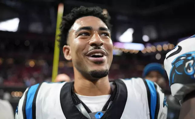 Carolina Panthers quarterback Bryce Young celebrates their overtime win against the Atlanta Falcons in an NFL football game, Sunday, Jan. 5, 2025, in Atlanta. (AP Photo/Mike Stewart)