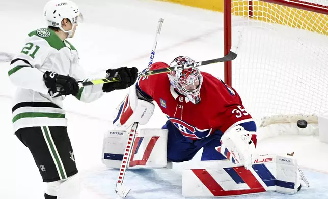 Dallas Stars' Jason Robertson (21) scores against Montreal Canadiens goaltender Sam Montembeault (35) during shootout NHL hockey game action in Montreal, Saturday, Jan. 11, 2025. (Graham Hughes/The Canadian Press via AP)