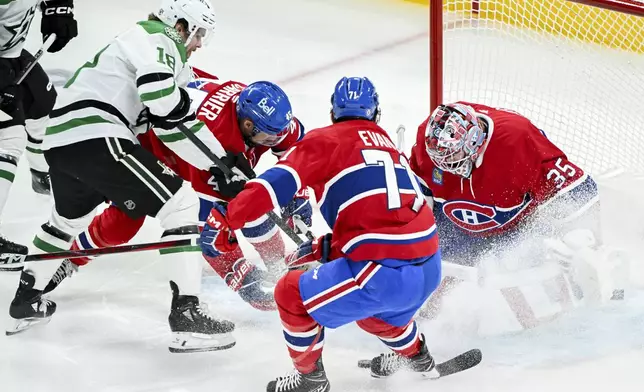 Dallas Stars' Sam Steel (18) moves in on Montreal Canadiens goaltender Sam Montembeault as Canadiens' Alexandre Carrier (45) and Jake Evans (71) defend during first period NHL hockey action in Montreal, Saturday, Jan. 11, 2025. (Graham Hughes/The Canadian Press via AP)