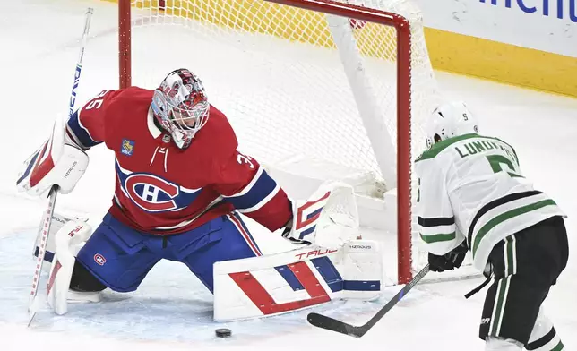 Dallas Stars' Nils Lundkvist (5) moves in on Montreal Canadiens goaltender Sam Montembeault during first period NHL hockey action in Montreal, Saturday, Jan. 11, 2025. (Graham Hughes/The Canadian Press via AP)