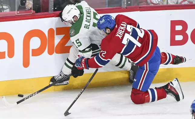 Dallas Stars' Colin Blackwell (15) and Montreal Canadiens' Arber Xhekaj (72) vie for the puck during first-period NHL hockey game action in Montreal, Saturday, Jan. 11, 2025. (Graham Hughes/The Canadian Press via AP)