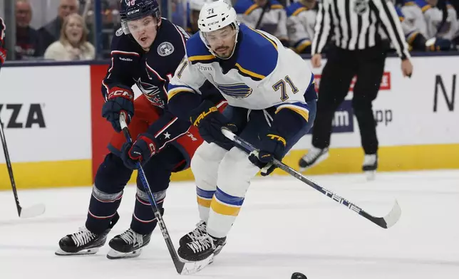 St. Louis Blues' Mathieu Joseph, right, and Columbus Blue Jackets' Dmitri Voronkov chase the puck during the third period of an NHL hockey game Saturday, Jan. 4, 2025, in Columbus, Ohio. (AP Photo/Jay LaPrete)