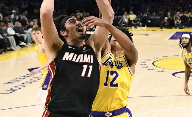 Miami Heat guard Jaime Jaquez Jr. goes up for a layup against Los Angeles Lakers guard Max Christie during the first half of an NBA basketball game Wednesday, Jan. 15, 2025, in Los Angeles. (AP Photo/Kevork Djansezian)