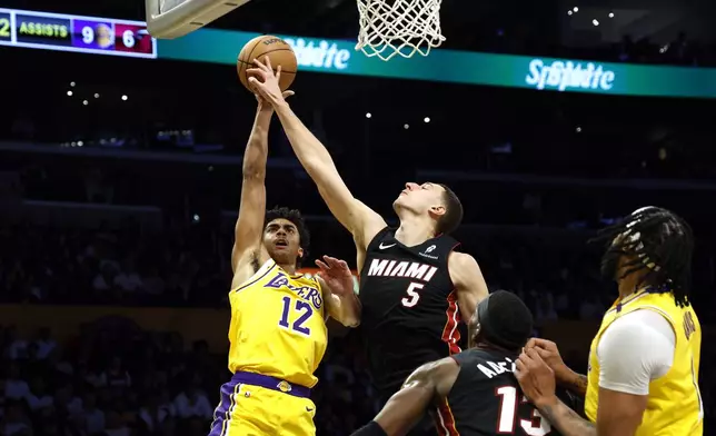 Los Angeles Lakers forward Los Angeles Lakers guard Max Christie has his shot blocked by Miami Heat forward Nikola Jovic during the first half of an NBA basketball game Wednesday, Jan. 15, 2025, in Los Angeles. (AP Photo/Kevork Djansezian)