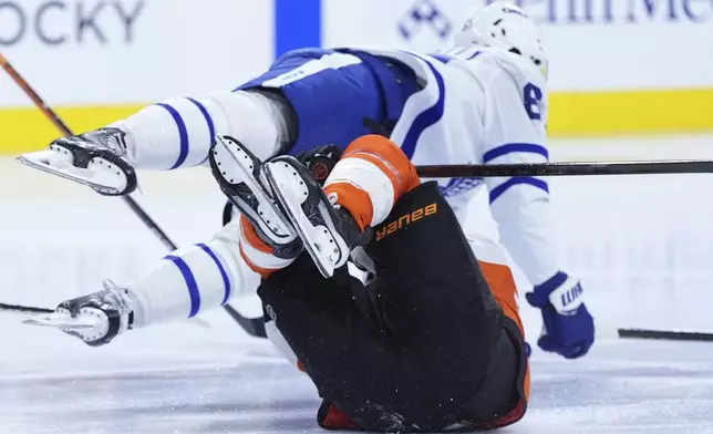 Toronto Maple Leafs' Max Pacioretty, top, collides with Philadelphia Flyers' Scott Laughton during the third period of an NHL hockey game, Tuesday, Jan. 7, 2025, in Philadelphia. (AP Photo/Matt Slocum)