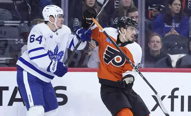 Toronto Maple Leafs' David Kampf, left, gets tangled up with Philadelphia Flyers' Morgan Frost during the second period of an NHL hockey game, Tuesday, Jan. 7, 2025, in Philadelphia. (AP Photo/Matt Slocum)