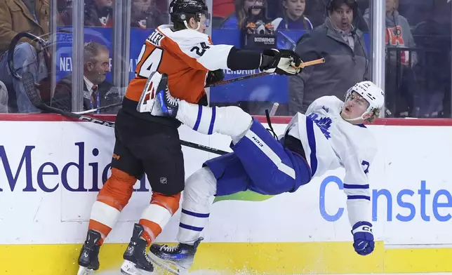 Toronto Maple Leafs' Bobby McMann, right, collides with Philadelphia Flyers' Nick Seeler during the third period of an NHL hockey game, Tuesday, Jan. 7, 2025, in Philadelphia. (AP Photo/Matt Slocum)