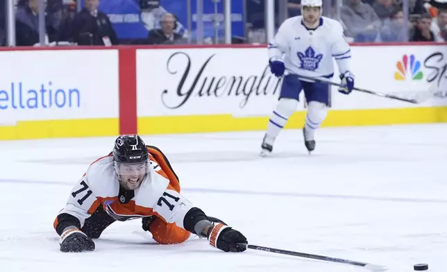 Philadelphia Flyers' Tyson Foerster stretches for the puck during the third period of an NHL hockey game against the Toronto Maple Leafs, Tuesday, Jan. 7, 2025, in Philadelphia. (AP Photo/Matt Slocum)