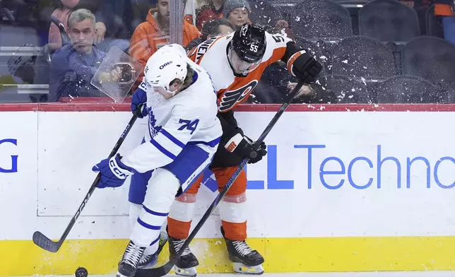 Toronto Maple Leafs' Bobby McMann, left, and Philadelphia Flyers' Rasmus Ristolainen collide during the second period of an NHL hockey game, Tuesday, Jan. 7, 2025, in Philadelphia. (AP Photo/Matt Slocum)