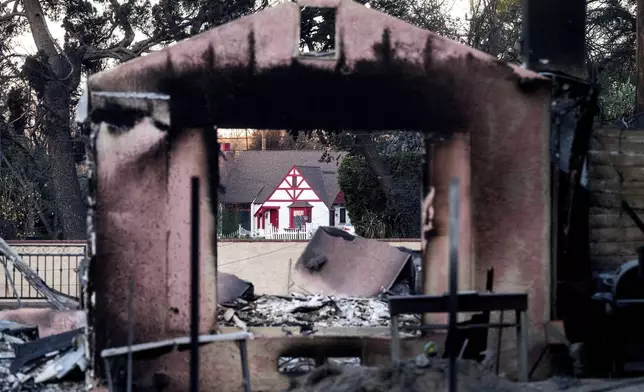 A home destroyed by the Eaton Fire stands in front of a home that survived in Altadena. Calif., on Monday, Jan. 13, 2025. (AP Photo/Noah Berger)