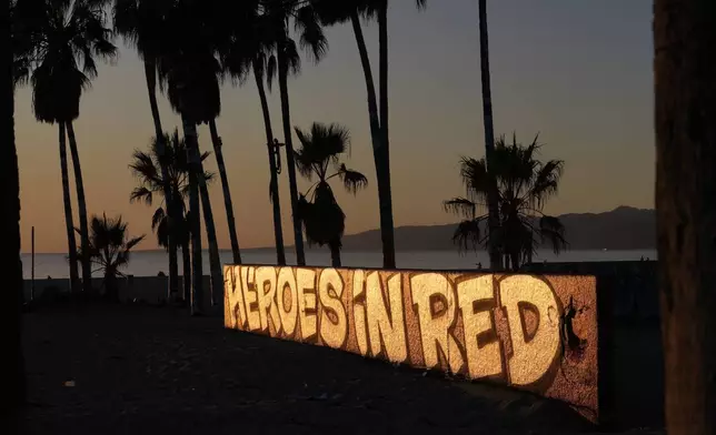 A mural by Sergei Statsenko, who also goes by the artist name Steeke, thanks firefighters in the Venice Beach area of Los Angeles as wildfires burn Monday, Jan. 13, 2025. (AP Photo/Damian Dovarganes)