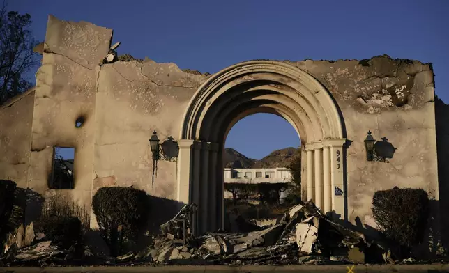 The facade of the Altadena Community Church stands amidst damage from the Eaton Fire on Monday, Jan. 13, 2025, in Altadena, Calif. (AP Photo/Carolyn Kaster)