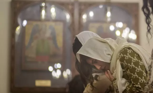 A Coptic Orthodox worshipper prays at Virgin Mary Church in Cairo, Monday, Jan. 6, 2025, marking Christmas according to the old Julian calendar. (AP Photo/Amr Nabil)