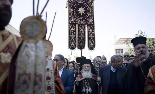 Patriarch Theophilos III, the Greek Orthodox Patriarch of Jerusalem, center, arrives at the Church of the Nativity, where Christians believe Jesus Christ was born, ahead of Christmas Eve mass in the West Bank city of Bethlehem, Monday, Jan. 6, 2025. (AP Photo/Maya Alleruzzo)