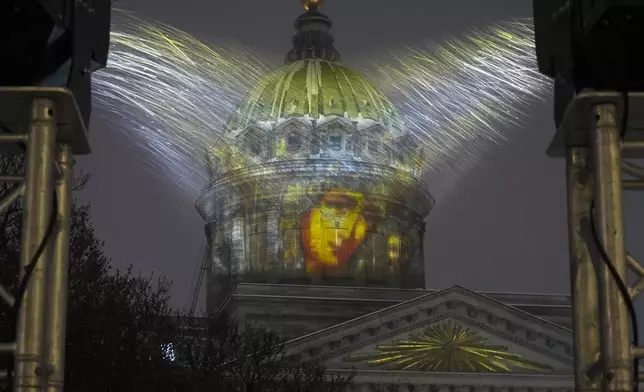 The Orthodox icon Virgin of Kazan is projected on the dome of Kazansky Cathedral in snowfall during the Orthodox Christmas celebrations in St. Petersburg, Russia, Tuesday, Jan. 7, 2025. (AP Photo/Dmitri Lovetsky)