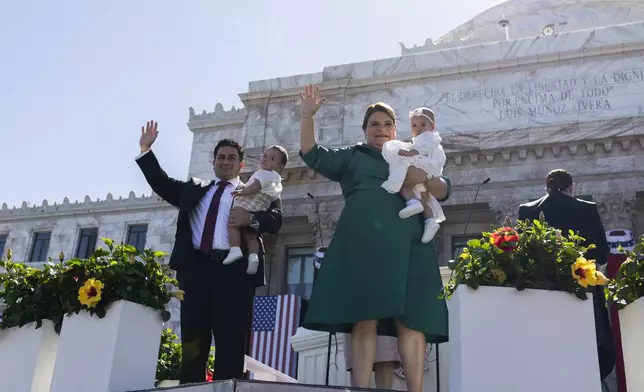 Jenniffer Gonzalez Colon and her husband Jose Yovin Vargas wave with their children during Gonzalez's swearing-in ceremony as governor outside the Capitol in San Juan, Puerto Rico, Thursday, Jan. 2, 2025. (AP Photo/Alejandro Granadillo)