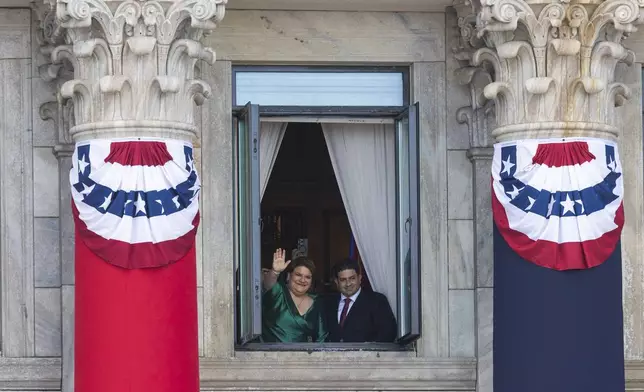 Jenniffer Gonzalez Colon waves next to her husband Jose Yovin Vargas, after her swearing-in ceremony as governor at the Capitol in San Juan, Puerto Rico, Thursday, Jan. 2, 2025. (AP Photo/Alejandro Granadillo)