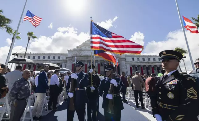 Soldiers carry U.S. and Puerto Rico flags during the inauguration ceremony of Jenniffer Gonzalez Colon as the new governor of Puerto Rico at the Capitol in San Juan, Thursday, Jan. 2, 2025. (AP Photo/Alejandro Granadillo)