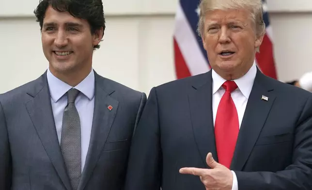 FILE - President Donald Trump and Canadian Prime Minister Justin Trudeau pose for a photo as Trudeau arrives at the White House in Washington, on Oct. 11, 2017. (AP Photo/Carolyn Kaster, File)