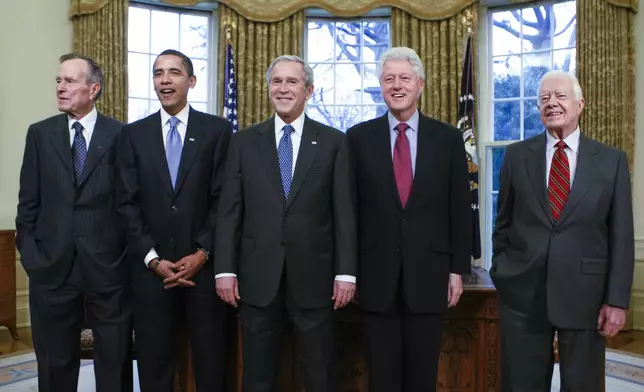 FILE — From left, former President George H.W. Bush, President-elect Barack Obama, President George W. Bush, former President Bill Clinton and former President Jimmy Carter meet in the Oval Office at the White House in Washington, on Jan. 7, 2009. (AP Photo/J. Scott Applewhite, File)